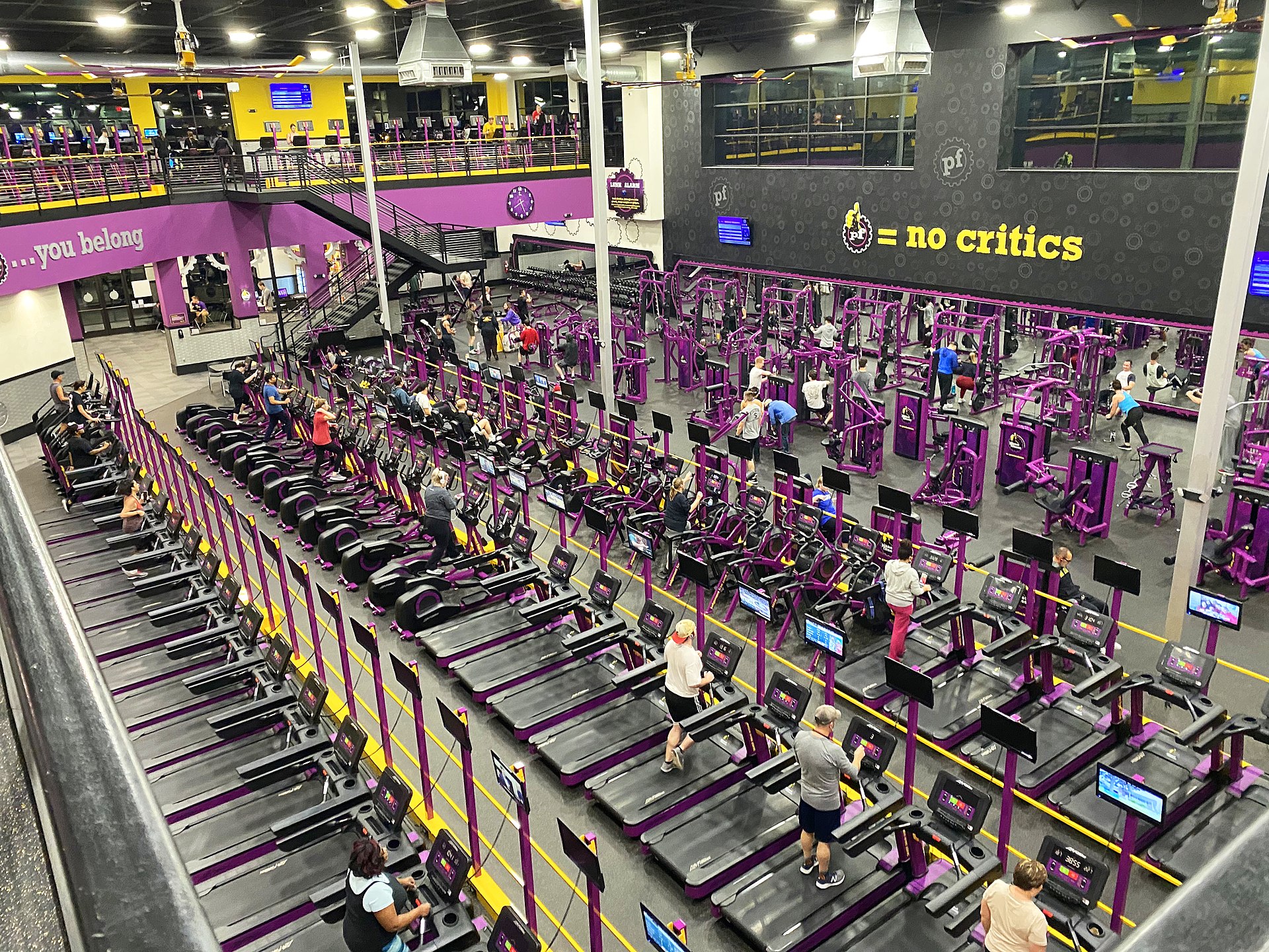 Planet Fitness gym interior — two-level facility with purple treadmills and strength equipment