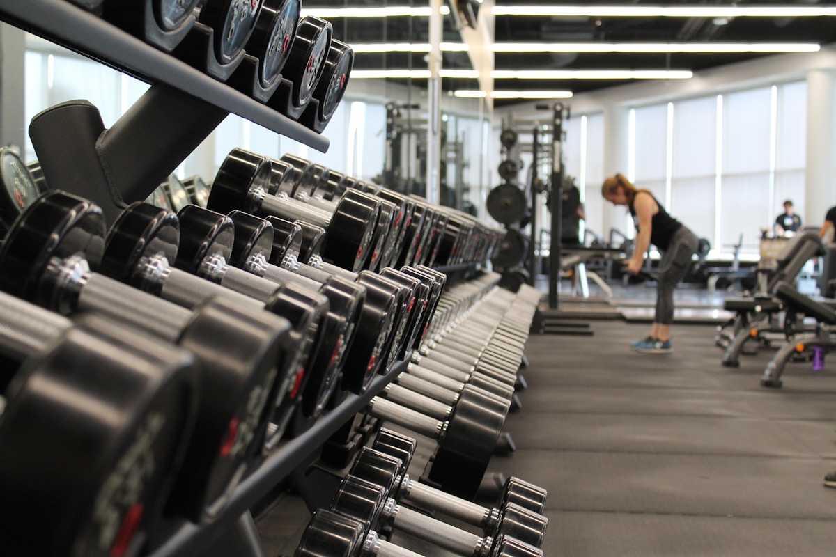 Young woman doing cardio workout on treadmill at the gym — teen fitness